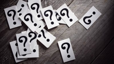 Question mark heap on table concept for confusion, question or s