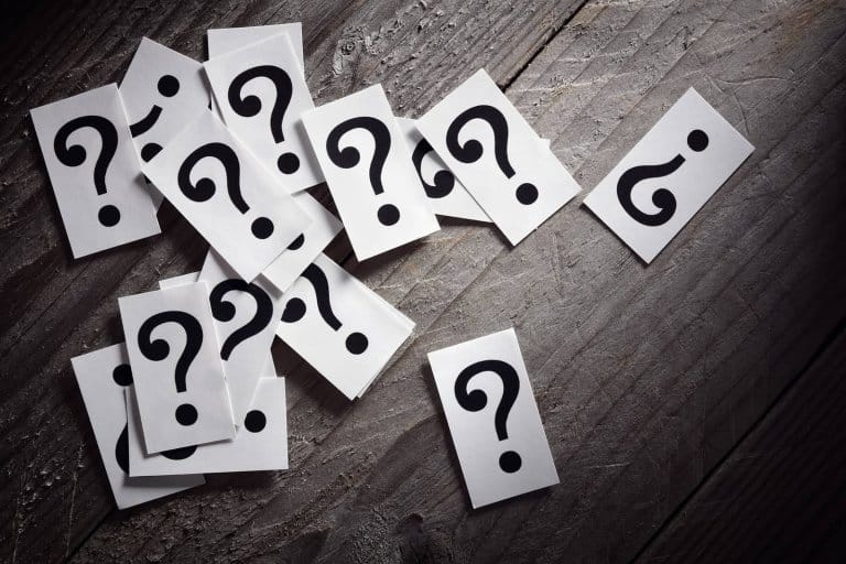 Question mark heap on table concept for confusion, question or s