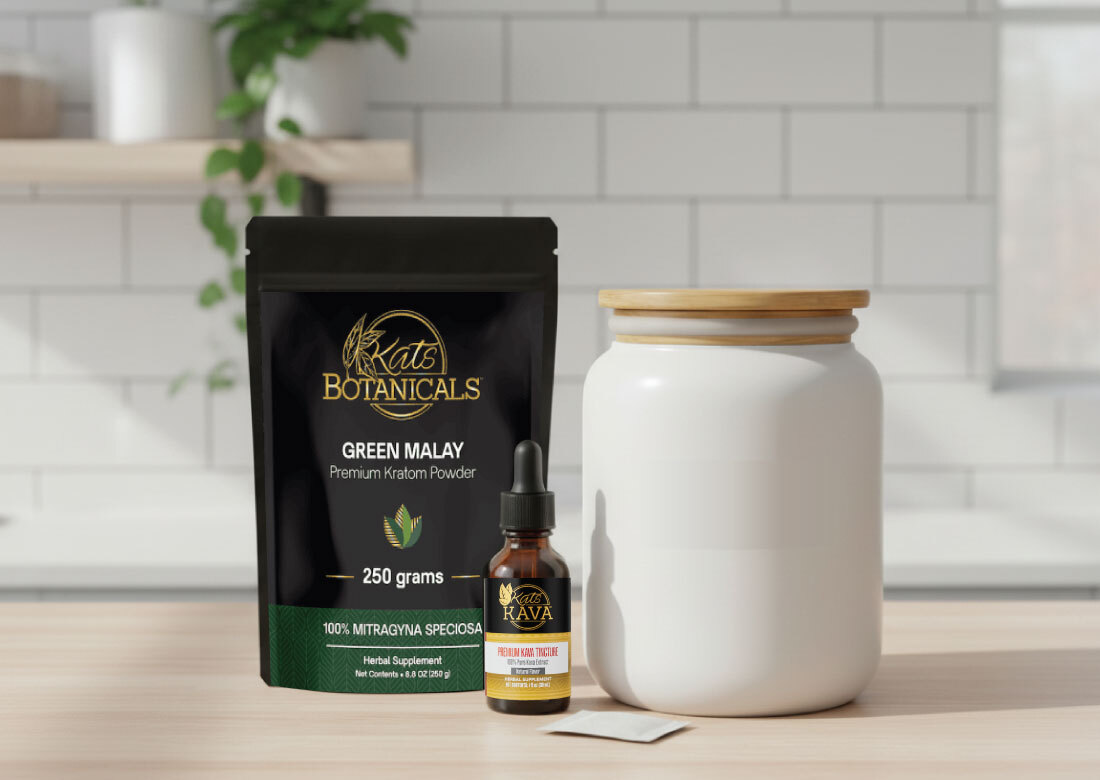A black bag labeled Kats Botanicals Green Malay Premium Kratom Powder, a brown dropper bottle labeled Vita Rava Melatonin Tincture, a white jar with a wooden lid, and a small white packet on a kitchen counter.