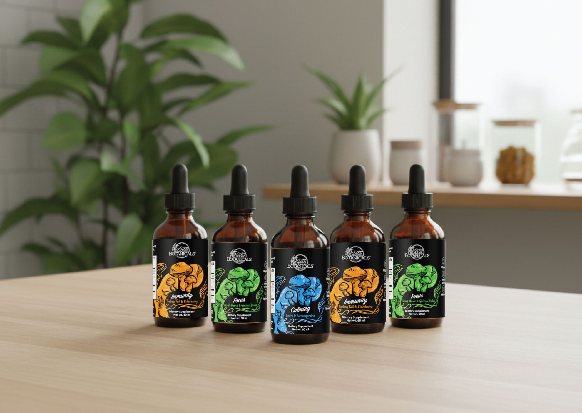 Five brown glass dropper bottles with colorful labels featuring muscle illustrations are arranged on a wooden table, with green plants and kitchen items in the blurred background.