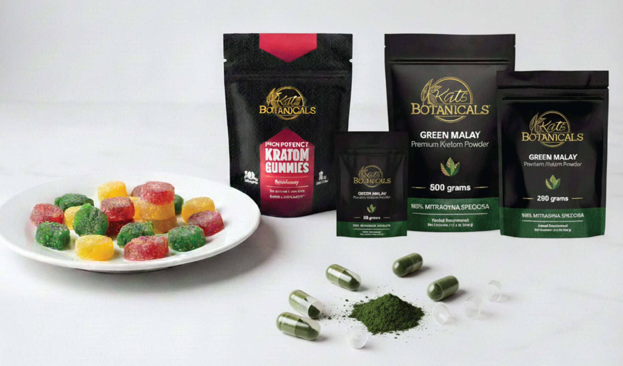  A selection of Kat’s Botanicals kratom products, including gummies, capsules, and powder, are displayed on a white surface. A plate of red, yellow, and green gummies is on the left, with powders and capsules shown on the right.