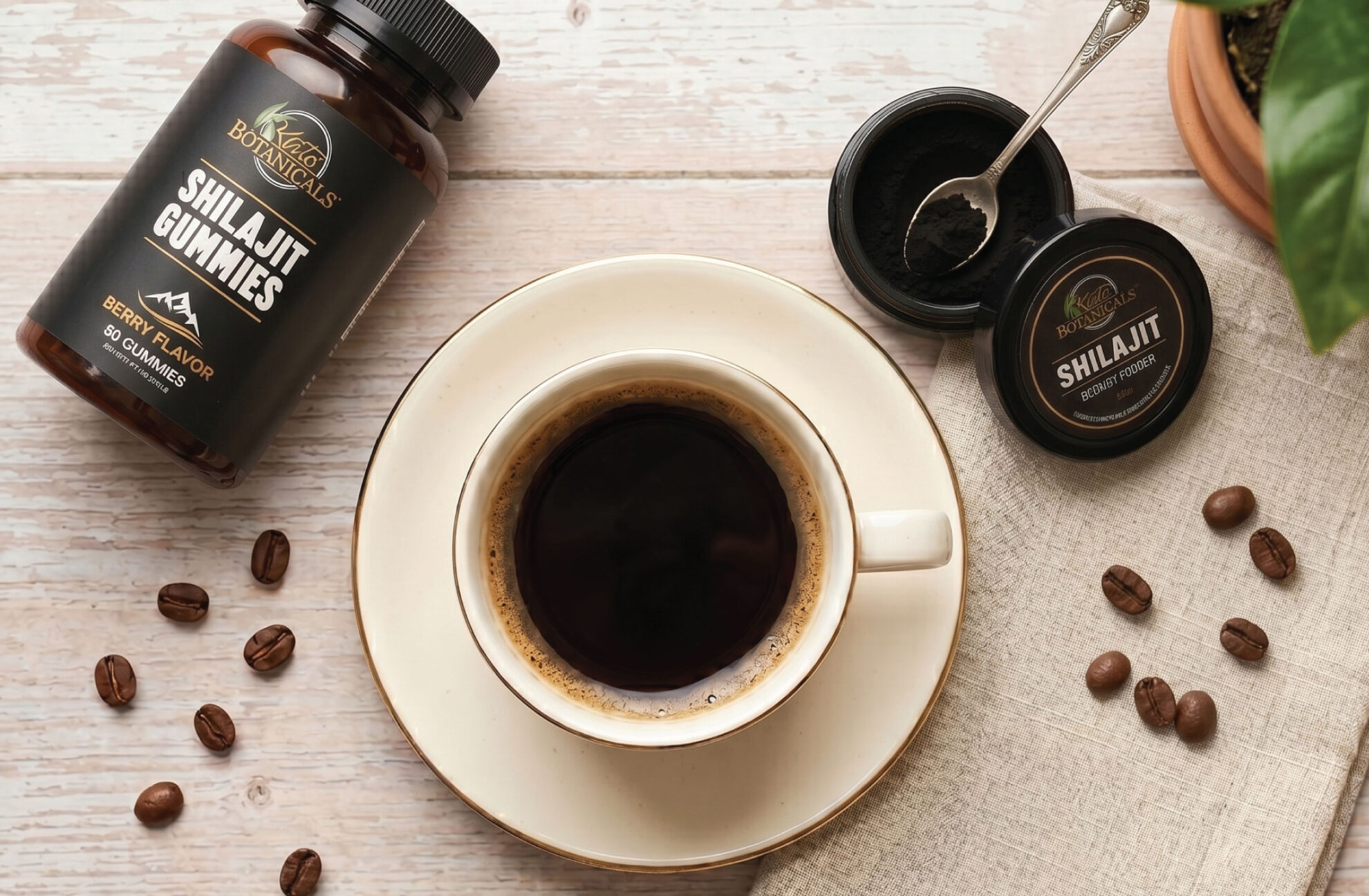 A cup of black coffee on a saucer sits on a wooden table next to a jar of Shilajit gummies, two containers of Shilajit resin—one open with a spoon—and scattered coffee beans.